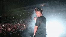 a man smoking a cigarette while standing on a stage