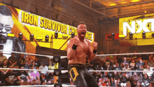 a wrestler in a ring with a sign that says iron survivor challenge