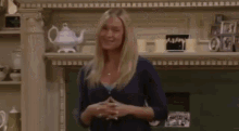 a group of women are sitting in a living room with a sign that says kkn on it