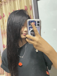 a woman taking a picture of herself in the mirror with her phone