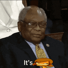 a man in a suit and tie says it 's while holding a cartoon character