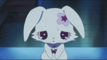 a white rabbit with a purple flower on its ears