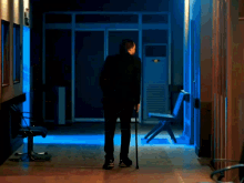 a woman in a blue jacket is sitting in a chair