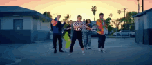 a group of people dancing in a parking lot