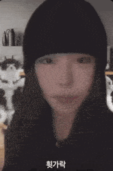 a woman in a black hat is standing next to two cats