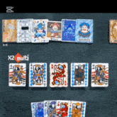 a bunch of playing cards are on a table with x2 multi written on the bottom right