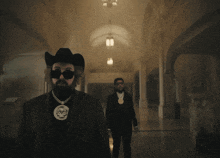 a man in a cowboy hat is smoking a cigarette