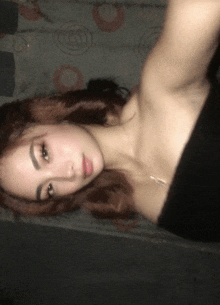 a woman taking a selfie with her shoulder visible