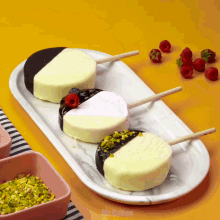 three desserts on a white plate with the words mr. cakes written on the bottom
