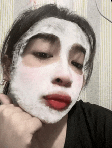 a woman with a white mask on her face