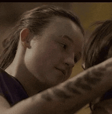 a close up of a person touching another person 's face .