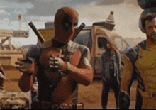 a man in a deadpool costume is standing next to a man in a yellow jacket