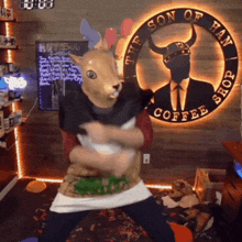 a man in a rabbit mask is dancing in front of a sign that says son of han coffee shop