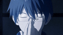 a man with blue hair and glasses is praying with his hands together