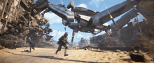 a man with a gun is running from a large robotic vehicle