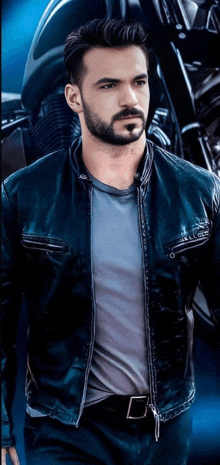 a man with a beard wears a black leather jacket