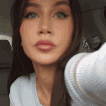 a close up of a woman taking a selfie in the back seat of a car