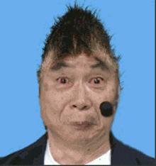 a man with a bug in his mouth and a smiley face on his face