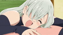 a girl with white hair is laying on a pink surface
