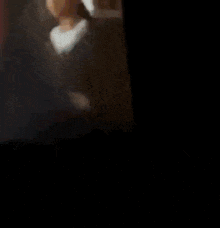 a blurred image of a person sitting in a chair
