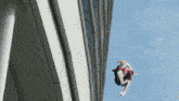 a person in a superhero costume is flying through the air