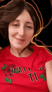 a woman is wearing a red shirt that says ti on it