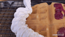 whipped cream is being poured on top of a waffle and the words made in animotica are visible