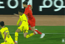 a soccer player with the number 8 on his jersey is being tackled by another player