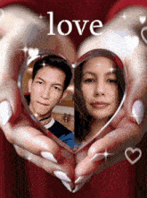 a man and a woman are holding a heart in their hands