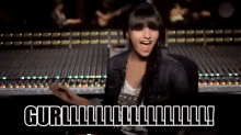 a woman is sitting in front of a mixer with the words gurl written on the screen