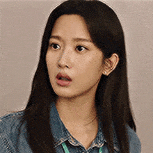 a close up of a woman 's face with a surprised look on her face .
