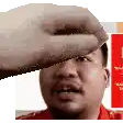 a hand is covering a man 's face with a towel .