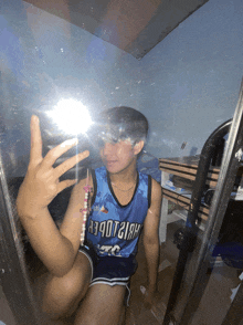 a person taking a picture of themselves in a mirror wearing a jersey that says ' arizona ' on it