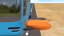 a blue bus is driving down a road with a pumpkin on the side of the road .