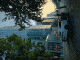 a white car is parked on the side of the road in front of a large building