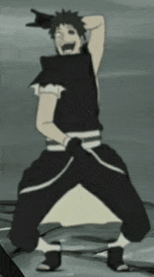 a man in a black shirt and black pants is standing with his hands on his head