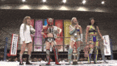 a group of women in a wrestling ring with a banner that says cosmic angels on it