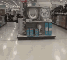 a store aisle with a display of baby products including swings