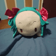 a stuffed animal with a pink bow on its head