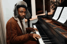 a man in a fur hat is playing the piano