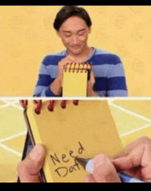 a man is holding a yellow notepad with the words need dat written on it .