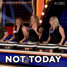 a group of women sitting at a table with a sign that says not today in front of them