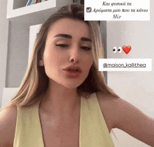 a woman in a yellow tank top with a sticker that says maison_kalithea
