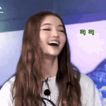 a woman with long hair is laughing with the letters ee on the bottom
