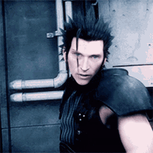 a man with a mohawk stands in front of a wall and pipes