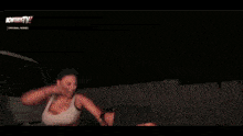 a blurred image of a man holding a sword with the words nowfirsttv on the bottom