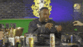 a man sitting at a table with a can of monster energy drink on it