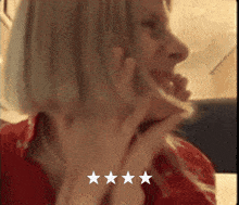 a close up of a woman 's face with three stars behind her