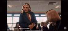 a woman in a suit and tie says i 'm not like homophobic on a screen
