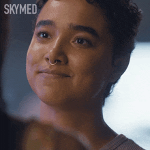 a close up of a woman 's face with the word skymed behind her